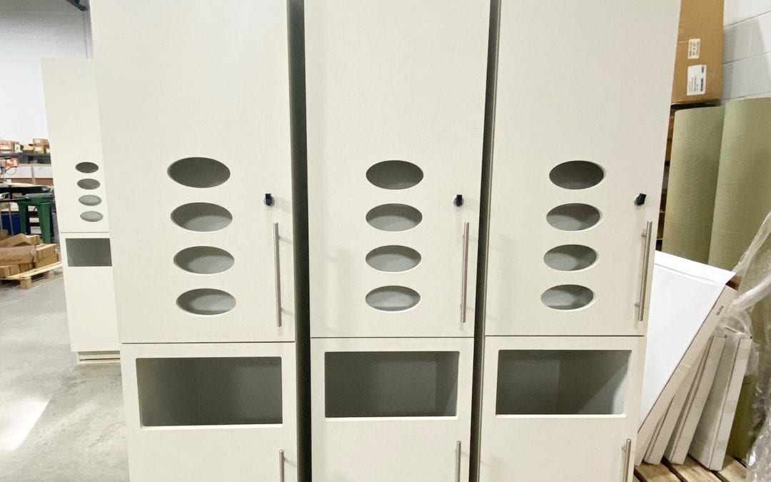 The latest exam room cabinets that are being built for @bidmchealth’s Plastic Surgery center in Boston, MA. These tall plastic laminate cabinets, finished with @arboritehpl Chambray Crème HPL, have custom oval cutouts for glove dispensing and an opening below for waste disposal. Contractor: @suffolkbuild. Architect: @e4harchitecture.