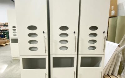 The latest exam room cabinets that are being built for @bidmchealth’s Plastic Surgery center in Boston, MA. These tall plastic laminate cabinets, finished with @arboritehpl Chambray Crème HPL, have custom oval cutouts for glove dispensing and an opening below for waste disposal. Contractor: @suffolkbuild. Architect: @e4harchitecture.